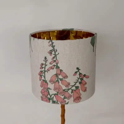 Beige och rosa lampskärm i 100 % linne med ett mönster av blommor, tillverkad av NORDRÅ Sweden som säljer presenter och inredning.